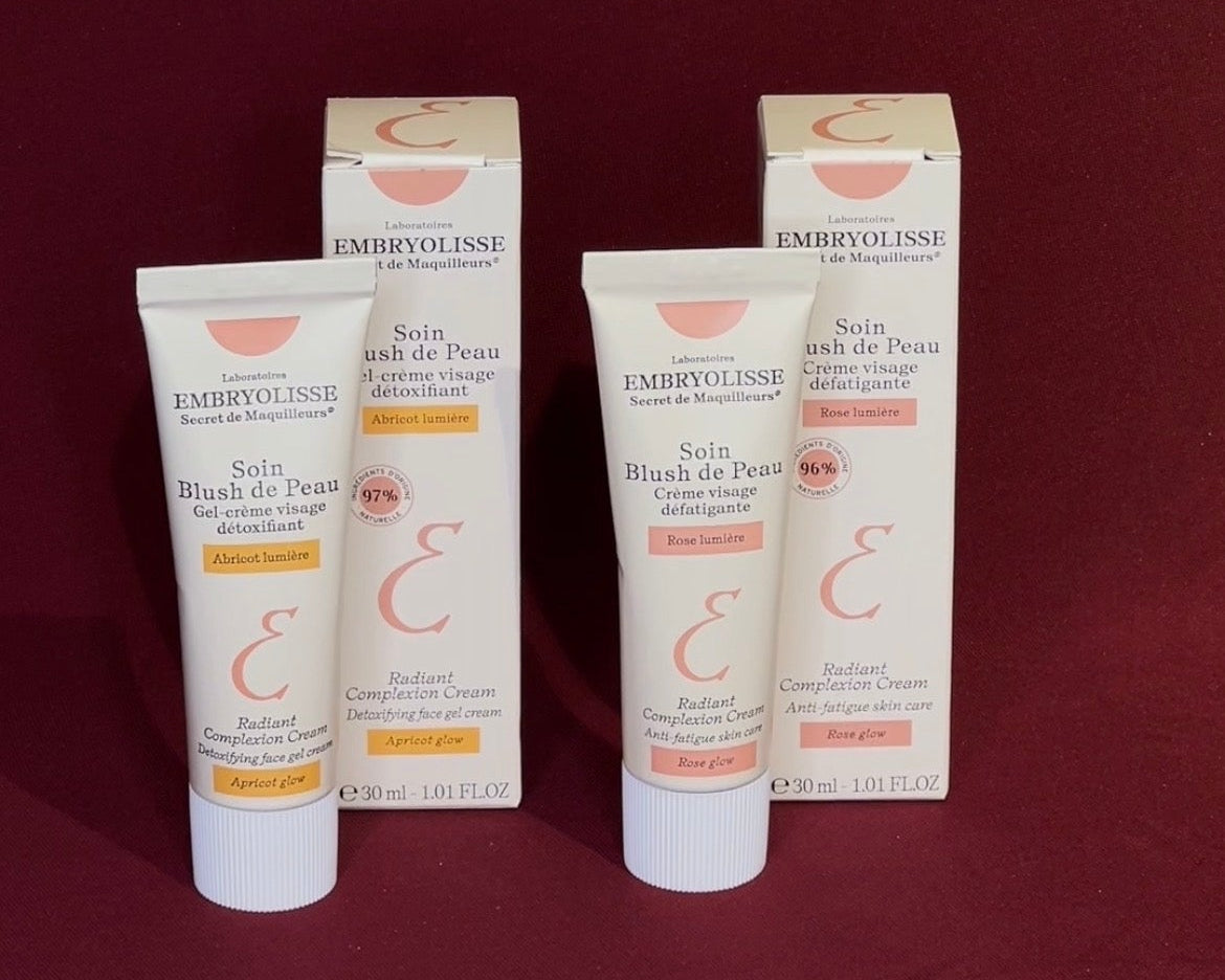 Embryolisse skincare products on a red background